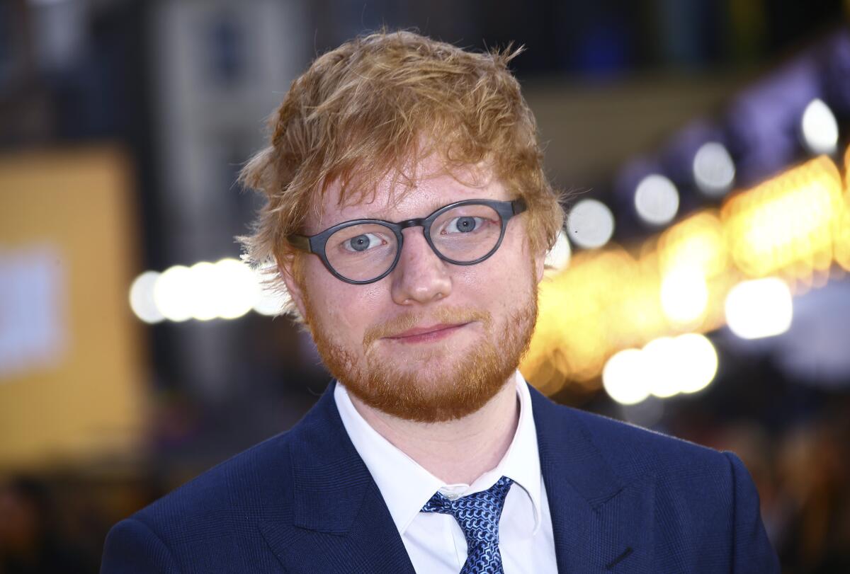 FILE - In this June 18, 2019, file photo, singer Ed Sheeran poses for photographers upon arrival at the premiere of the film "Yesterday'" in London. Sheeran will perform in a concert to kick off the NFL season opener in Florida next month. The NFL announced Friday, Aug. 6, that Sheeran will headline a pregame concert in Tampa, Fla. The British pop star's performance will take place before the reigning Super Bowl champion Tampa Bay Buccaneers face off against the Dallas Cowboys. (Photo by Joel C Ryan/Invision/AP, File)