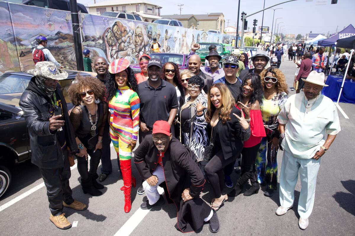 A group poses for a photo at the "Pull Up at the Wall" event in South Los Angeles.