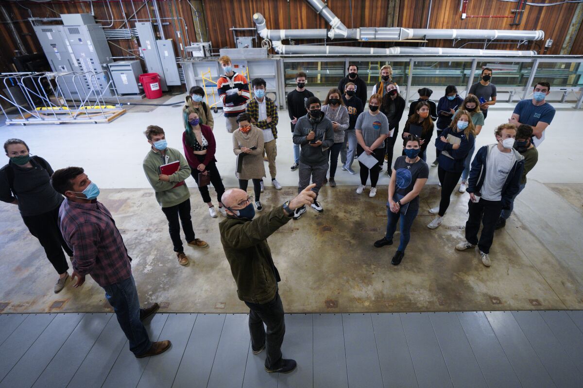 Researcher Grant Deane speaks with undergraduate students about UC San Diego's new ocean and atmosphere simulator.