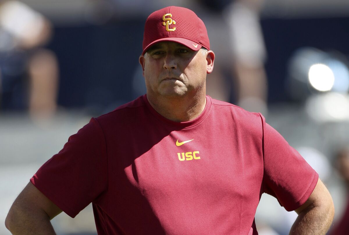 USC coach Clay Helton watches his players warm up before Saturday's game against BYU.