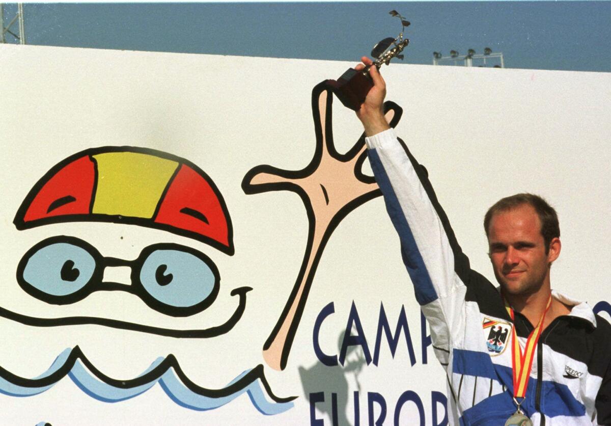 FILE - German gold medalist in the 10 meter diving competition Jan Hempel, poses with his trophy on Aug. 18, 1997 in the European Swimming Championships in Seville, Spain. Former Olympic diver Jan Hempel has accused the German swimming federation of failing to heed his complaints of his years-long sexual abuse by former coach Werner Langer. “The federation (DSV) suggested to me that if I spread that around, it would put our sport in danger and then you can’t take part in your sport anymore. Of course, I was at a level where I had goals in mind and I wanted to reach them,” Hempel told news agency DPA on Friday, Aug. 19, 2022. (AP Photo/Christof Stache, File)