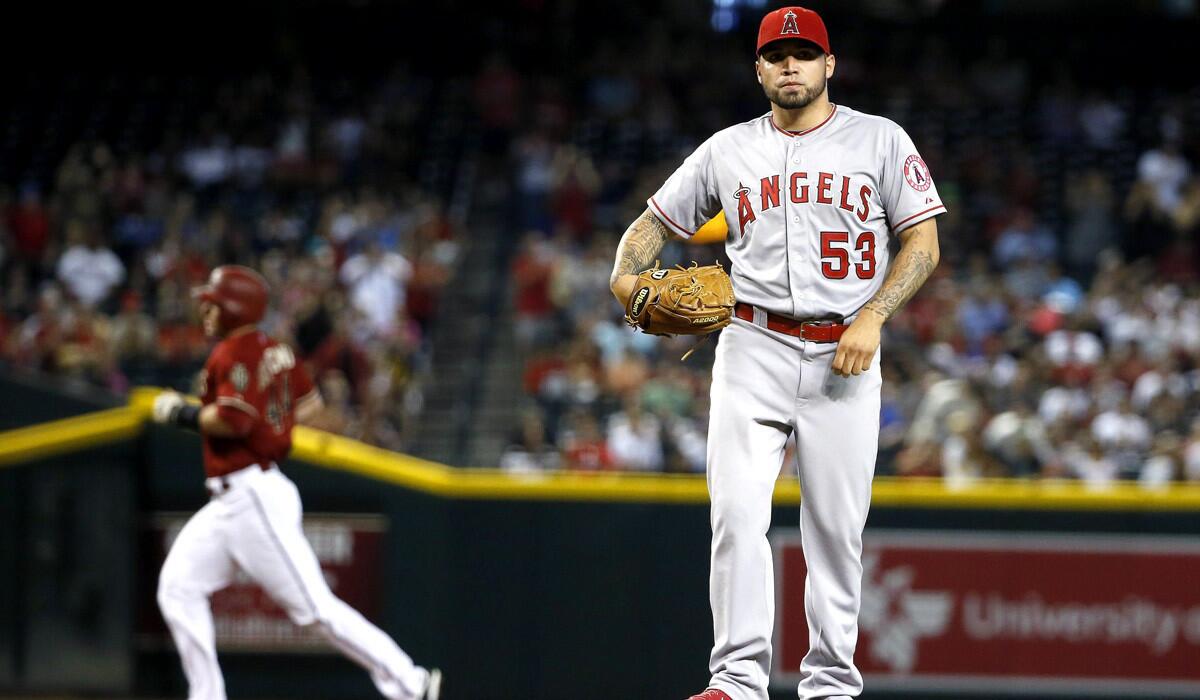 Los Angeles Angels' Hector Santiago stands on the mound after giving up a home run to Arizona Diamondbacks' Paul Goldschmidt, during the Angels' 3-2 loss to the Diamondbacks on Wednesday.