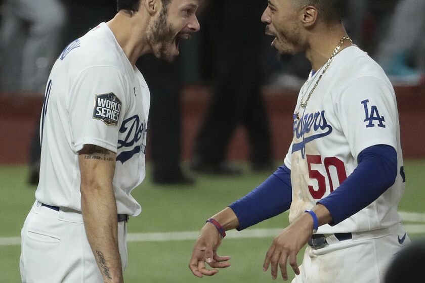 Mookie Betts and Joe Kelly share a moment as the Dodgers celebrate winning the World Series at Globe Life Field.
