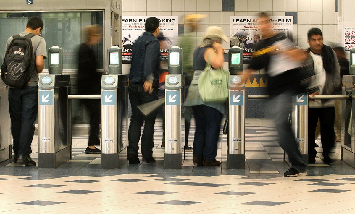 Riders pass through the turnstiles of the Universal City/Studio City Metro Red Line station.