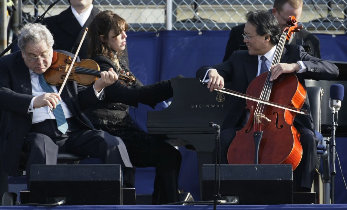 Cellist Yo-Yo Ma, right, violinist Itzhak Perlman, left, and pianist Gabriela Montero perform John Williams' "Air and Simple Gifts" during the inauguration of Barack Obama on the West Front of the Ca