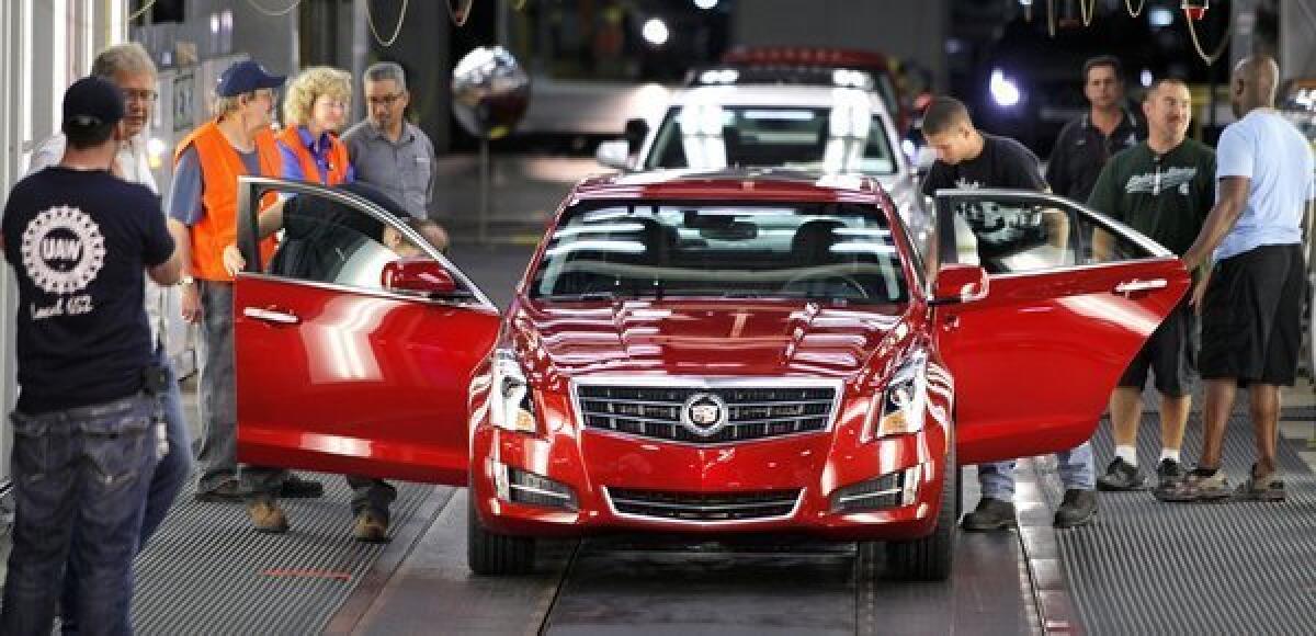 A 2013 Cadillac ATS rolls off a General Motors assembly line in Lansing, Mich.