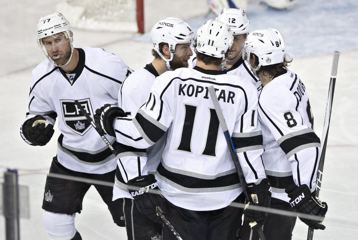 Los Angeles Kings' Jeff Carter, left, Jake Muzzin, Anze Kopitar, Marian Gaborik and Drew Doughty celebrate a goal against the Edmonton Oilers on Tuesday night.