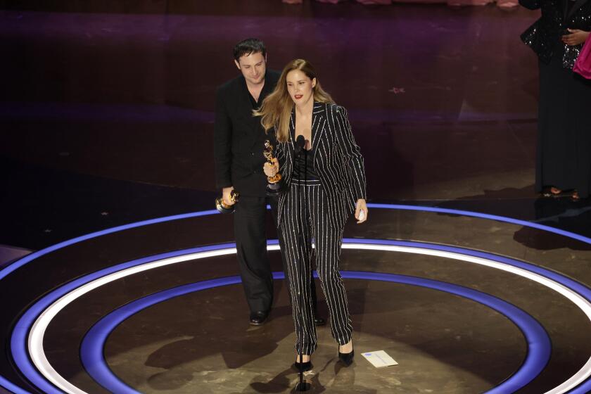 Hollywood, CA - March 10: Justine Triet and Arthur Harari during the live telecast of the 96th Annual Academy Awards in Dolby Theatre at Hollywood & Highland Center in Hollywood, CA, Sunday, March 10, 2024. (Myung J. Chun / Los Angeles Times)