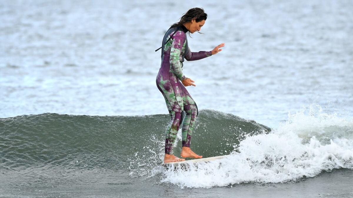 Kassia Meador walks the length of her board at First Point.