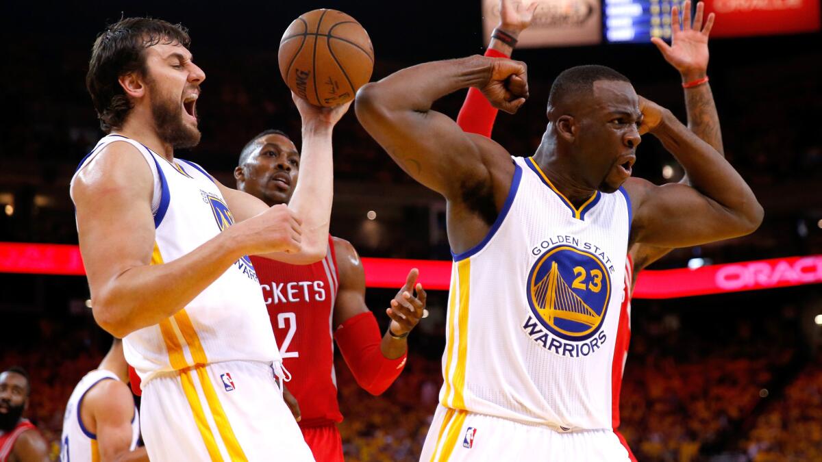 Warriors forward Draymond Green (23) and center Andrew Bogut react after Green scored against the Rockets in Game 5 of their playoff series on Wednesday night in Oakland.