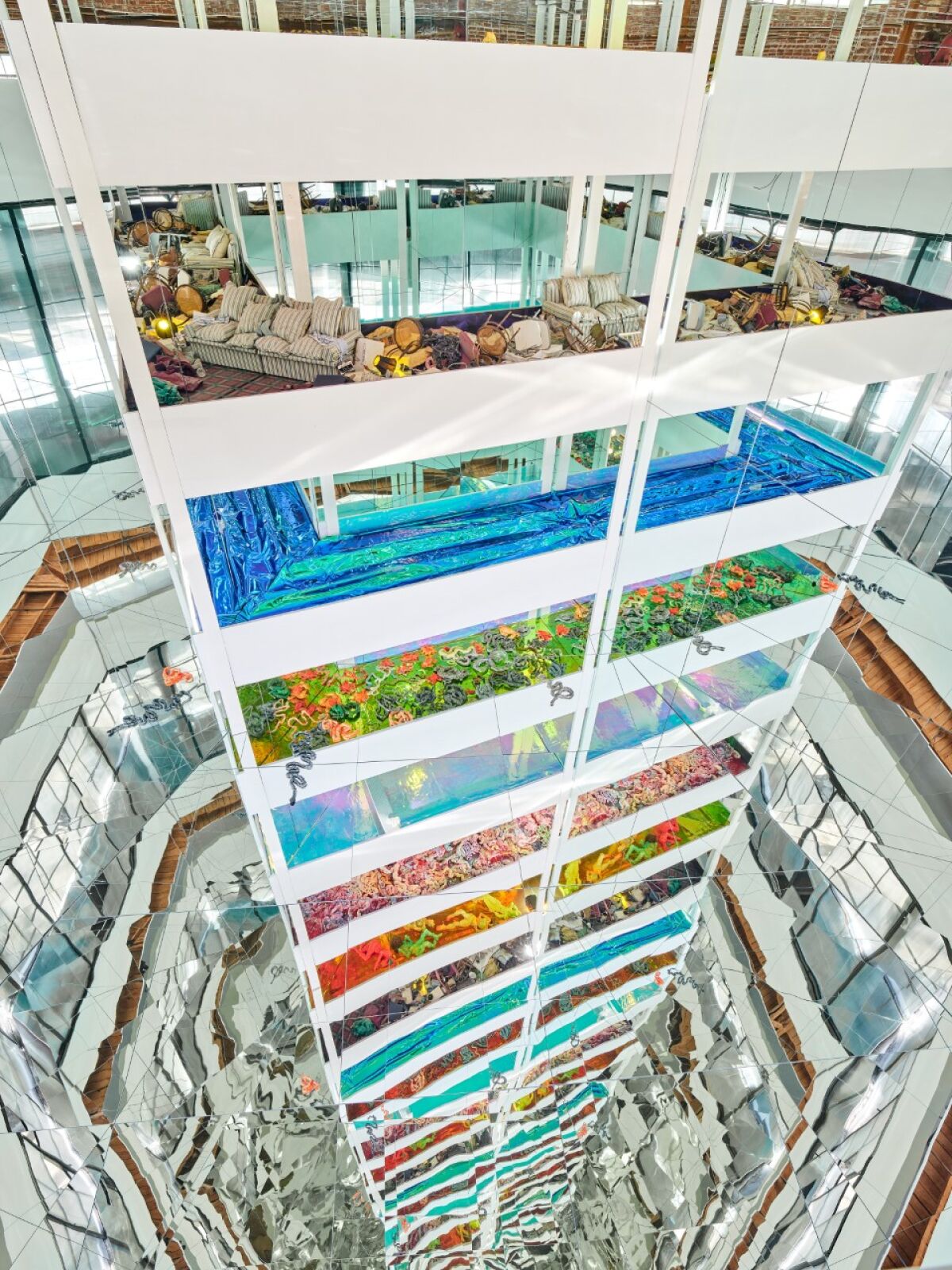 Levels containing various scenes are reflected in trapezoidal mirrors.