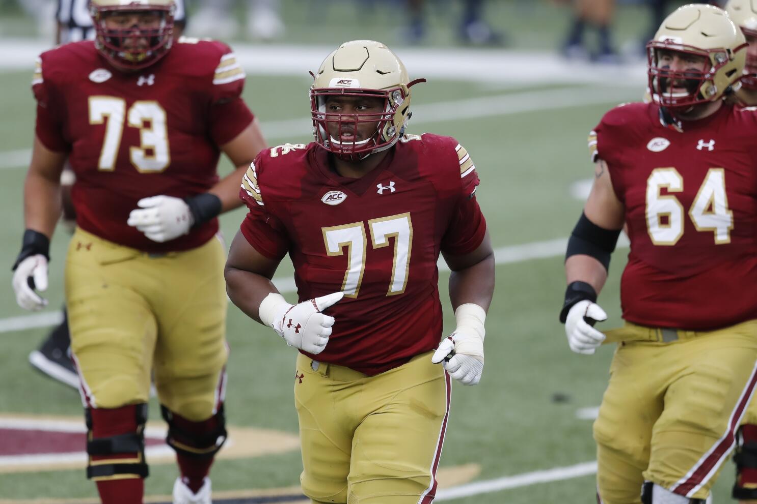 Boston College offensive guard Zion Johnson holds a team jersey