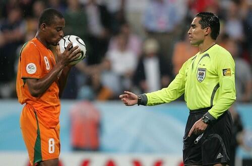 Ivory Coast's Bonaventure Kalou, left, kisses the ball before his penalty kick during the Ivory Coast v Serbia & Montenegro.