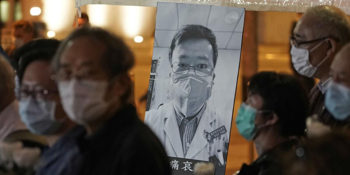 A photo of Dr. Li Wenliang is displayed during a vigil on Feb. 7. Wenliang was officially reprimanded for warning about the coronavirus outbreak and later died of the disease.