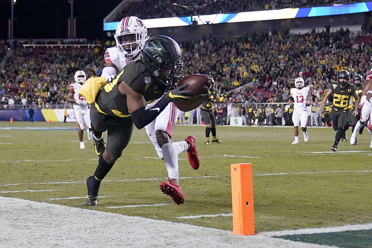 Oregon wide receiver Jaylon Redd (30) is pushed out of bounds by Utah defensive back Josh Nurse (14) short of the goal line during the first half of the Pac-12 championship game on Friday in Santa Clara.