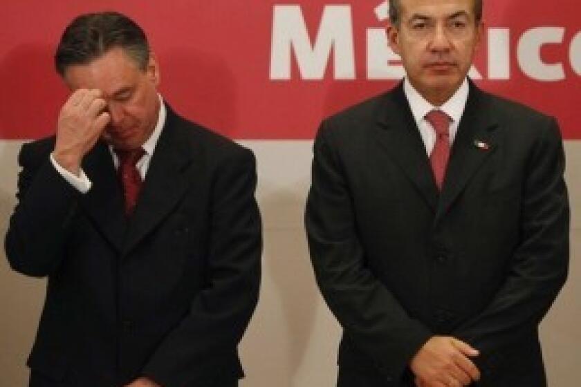 Eduardo Medina Mora, left, stands with President Felipe Calderon as he announces his departure. Medina Mora was Calderons point man on the drug war.