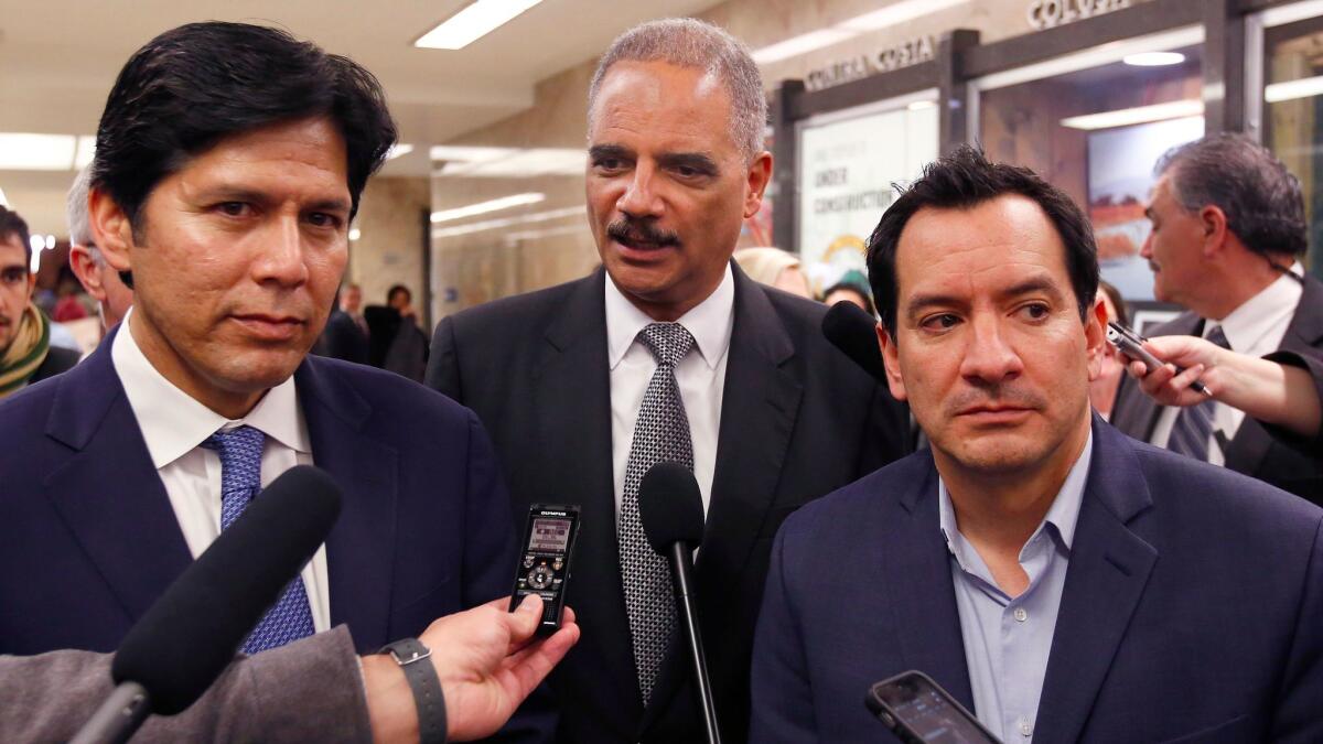 California Senate President Pro Tem Kevin de León (D-Los Angeles), left, and Assembly Speaker Anthony Rendon (D-Paramount) talk to reporters in Sacramento with former U.S. Atty. Gen. Eric Holder.