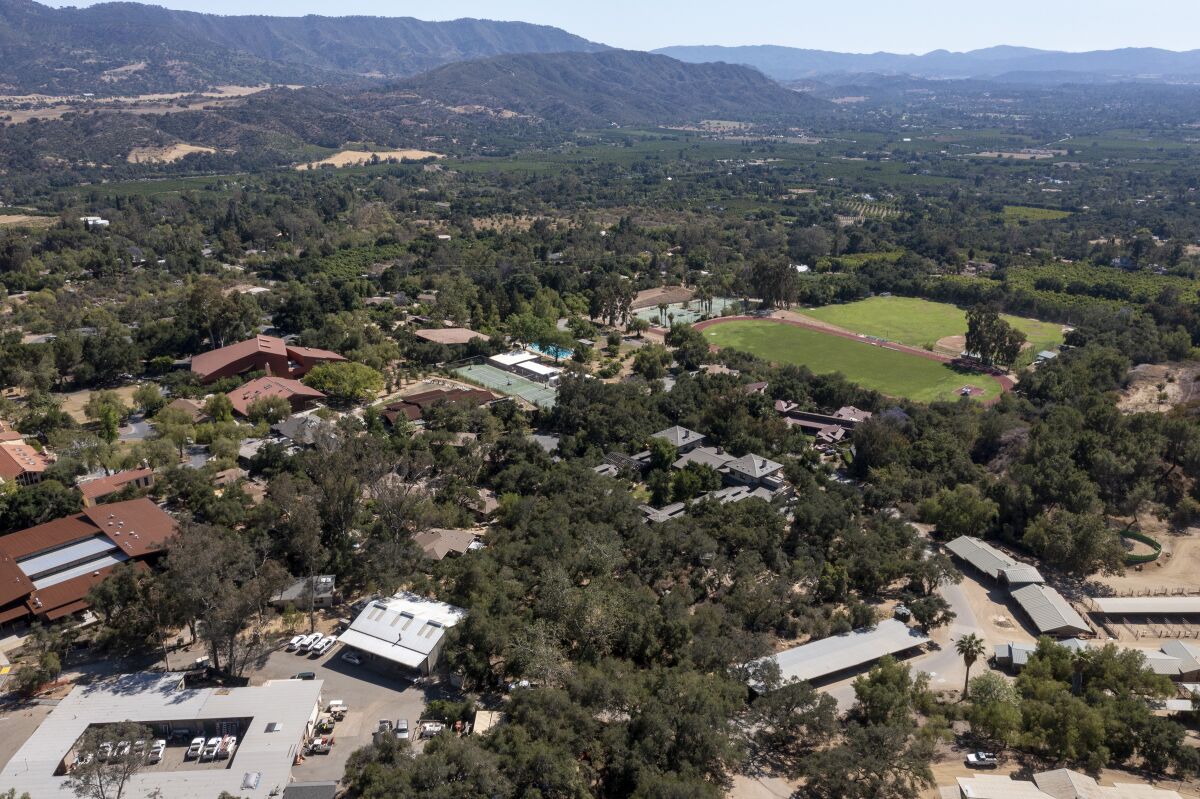 An aerial view of a school campus with sports fields