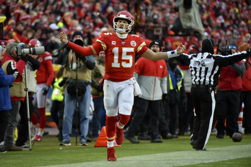 Kansas City Chiefs quarterback Patrick Mahomes (15) celebrates after carrying the ball during the first half of an NFL divisional playoff football game against the Houston Texans, in Kansas City, Mo., Sunday, Jan. 12, 2020. (AP Photo/Ed Zurga)