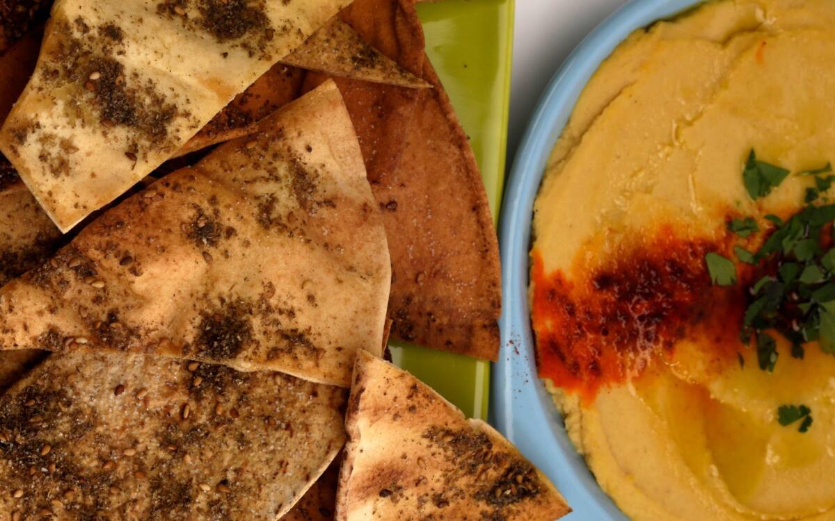 Baked chips with roasted garlic hummus