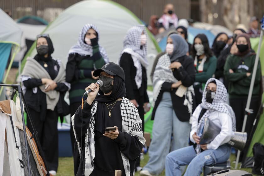 SAN DIEGO, CA - MAY 01, 2024: A pro-Palestinian protester uses a microphone to lead chants as UCSD students protest the war in Gaza at an encampment they set up at UCSD in San Diego on Wednesday, May 01, 2024.