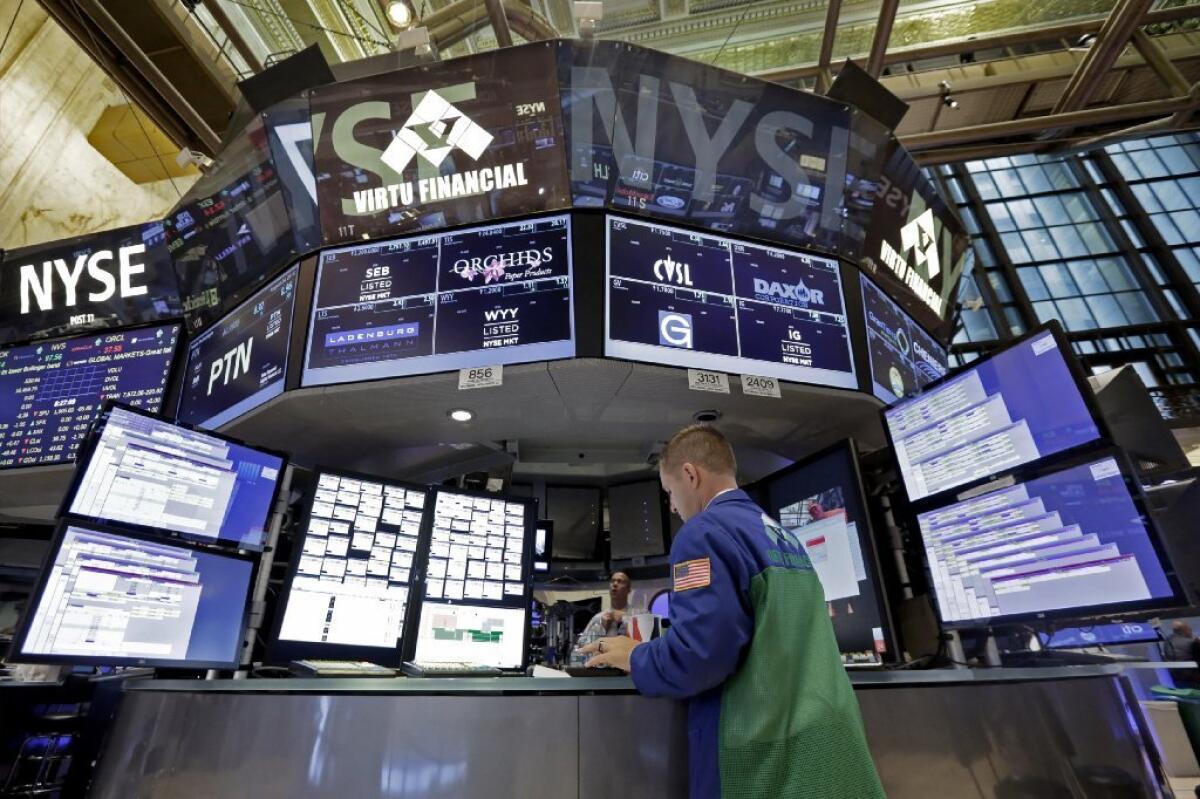 Specialist David Vadala prepares for the day's trading on the floor of the New York Stock Exchange on Monday. The Dow Jones industrial average closed with a loss of 588.47 points, or down about 3.6%.