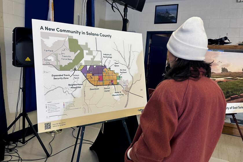 FILE - A map of a new proposed community in Solano County, Calif., is displayed during a news conference in Rio Vista, Calif. on Jan. 17, 2024. A billionaire-backed proposal to build an eco-friendly California city from scratch is off to a bumpy start in qualifying its voter initiative for the Nov. 5 ballot. The deadline for the Solano County counsel's office to give California Forever the ballot title they need to start gathering signatures is Thursday, Feb. 29. (AP Photo/Janie Har, File)