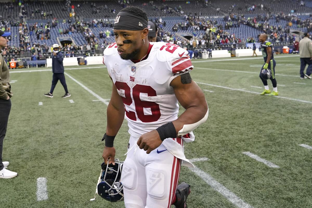 New York Giants running back Saquon Barkley (26) leaves the field after an NFL football game against the Seattle Seahawks in Seattle, Sunday, Oct. 30, 2022. (AP Photo/Marcio Jose Sanchez)