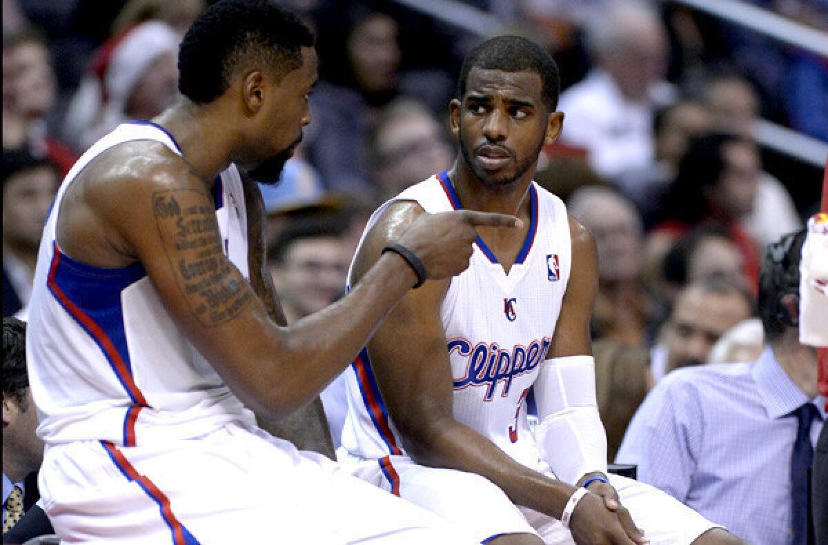 Clippers teammates DeAndre Jordan, left, and Chris Paul talk during a break in a game against the New Orleans Pelicans earlier this season.