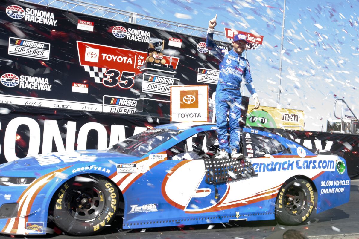 Kyle Larson stands atop his car after winning a NASCAR Cup Series race, Sunday, June 6, 2021, at Sonoma Raceway in Sonoma, Calif. (AP Photo/D. Ross Cameron)