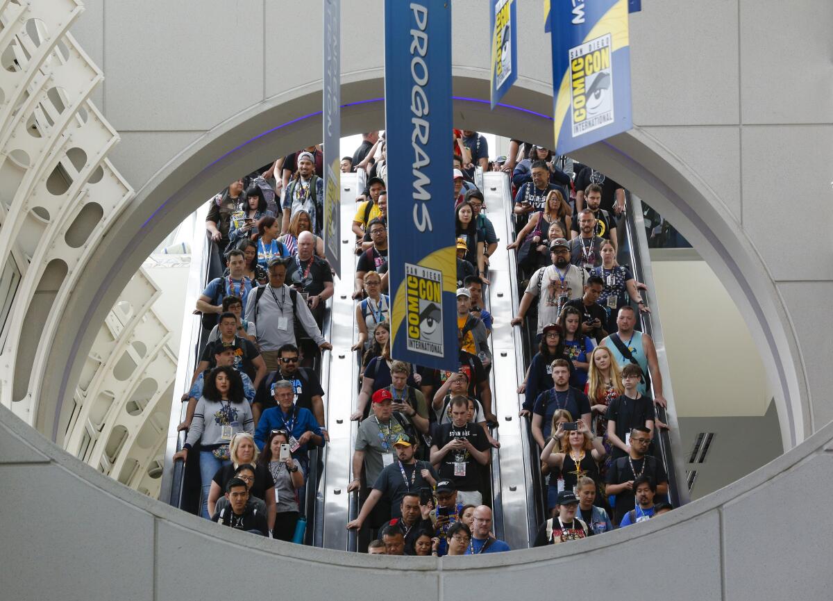 On opening day for Comic-Con International, fans ride a pack escalator down towards the main convention floor for Comic-Con.