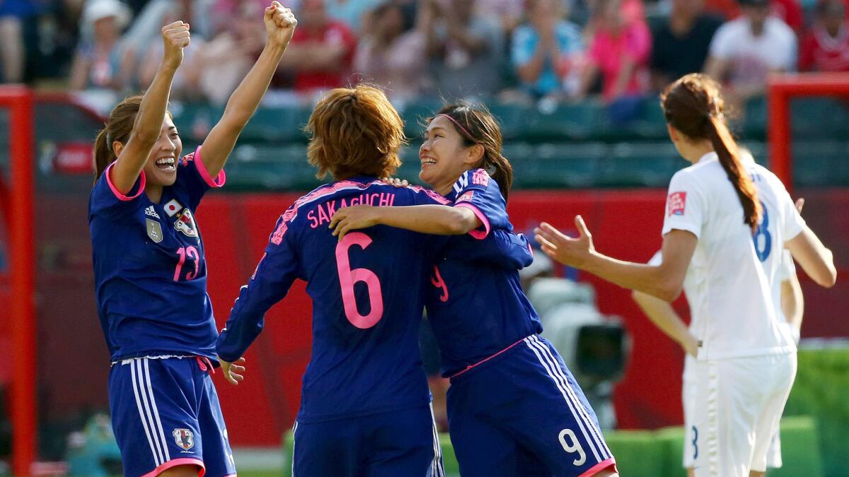 Japan players (from left) Rumi Utsugi, Mizuho Sakaguchi and Nahomi Kawasumi celebrate after scoring a second goal against England in stoppage time of their Women's World Cup semifinal on Wednesday in Edmonton.