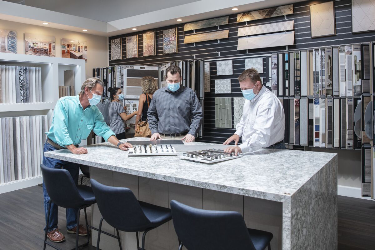 The Jackson Design & Remodeling team guides visitors on a private tour of the company’s newly remodeled showroom.