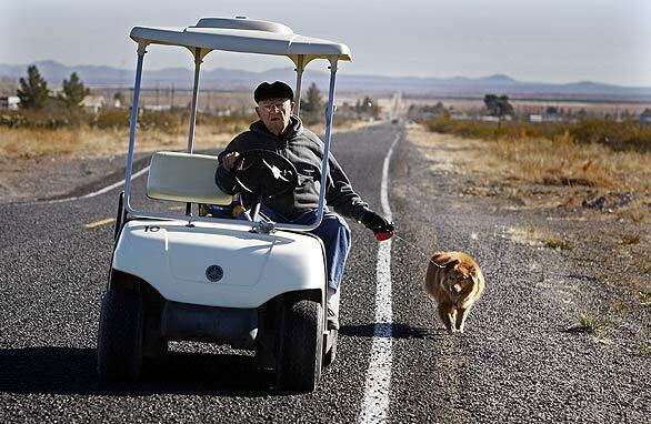 Ken Henrics , 86, walks his dog.