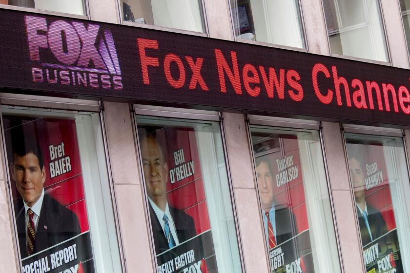 Posters featuring Fox News talent including one of Bill O'Reilly, second from right, are displayed on the News Corp. headquarters building in Midtown Manhattan, Wednesday, April 19, 2017. Bill O'Reilly has lost his job at Fox News Channel following reports that five women had been paid millions of dollars to keep quiet about harassment allegations. (AP Photo/Mary Altaffer)