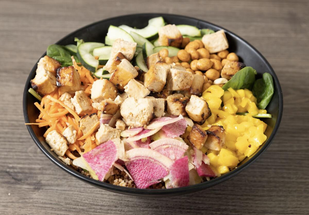 The Let Your ManGo bowl includes spinach, quinoa, tofu, carrots, cucumbers, mango, watermelon radish and Japanese peanuts.