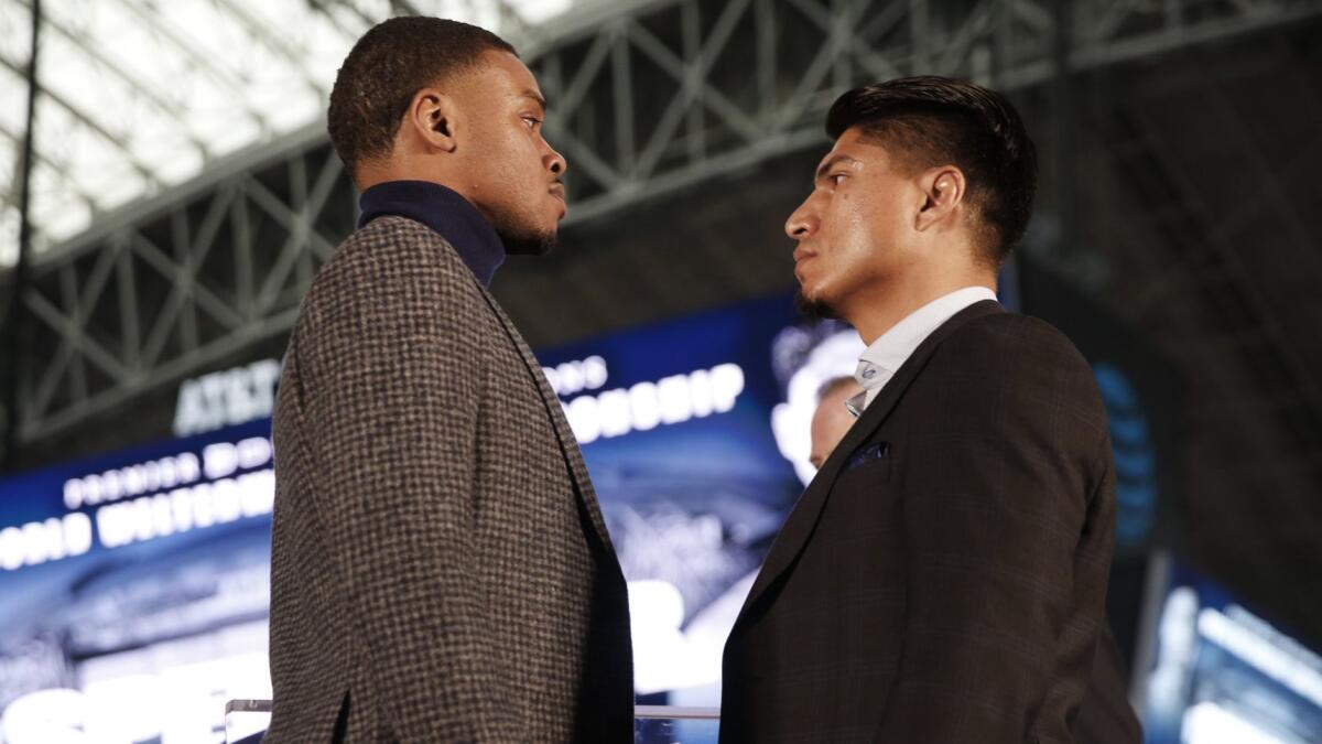 Errol Spence Jr., left, and Mikey Garcia stare down one another during a Feb. 19 promotional event at AT&T Stadium in Arlington, Texas.