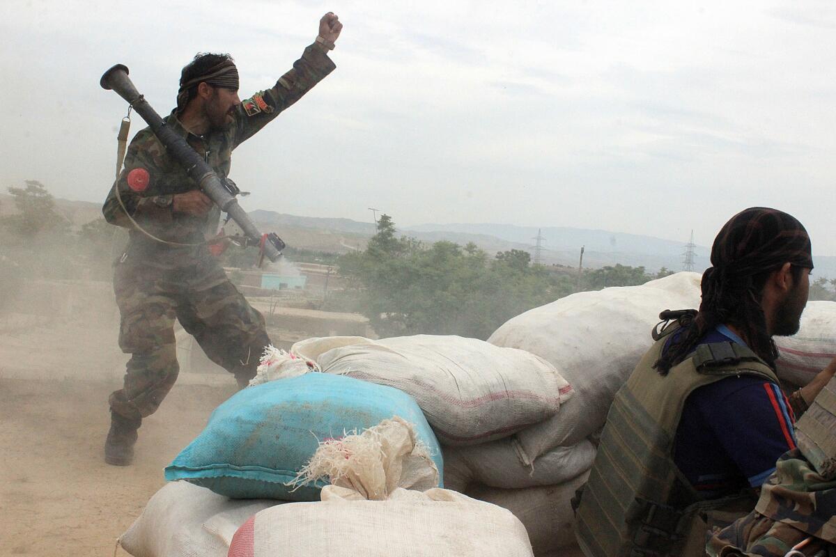 An Afghan National Army soldier shouts against the Taliban after firing a rocket toward its positions on the outskirts of Kunduz, northern Afghanistan, on Saturday.