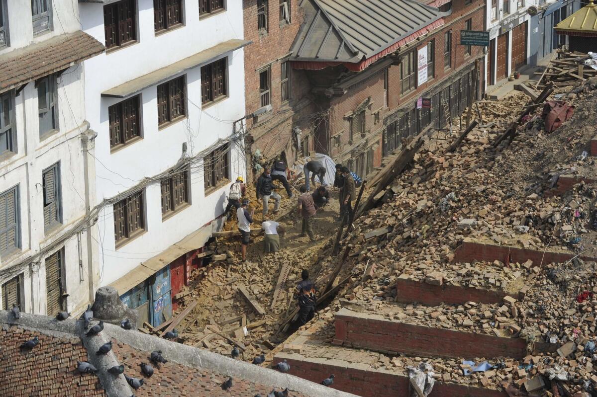 People search through the rubble at the earthquake-damaged Durbar Square in Katmandu, Nepal's capital, on April 28.