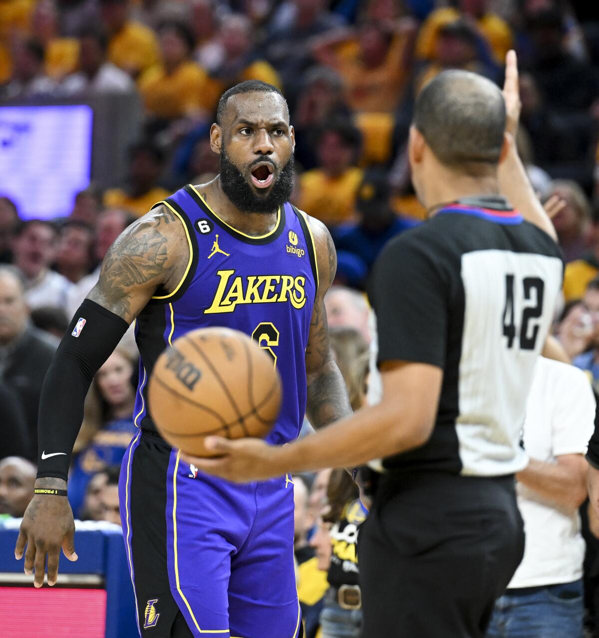 Lakers forward LeBron James reacts after a foul is called on him by referee Eric Lewis.