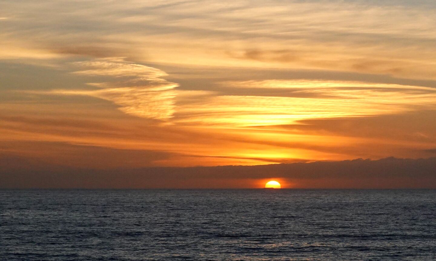 The setting sun paints the sky over La Jolla Shores.