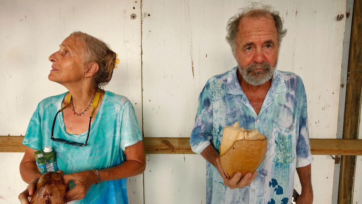 Sloop Jones, and his partner Charlotte Seashore, left, plan to stay and rebuild no matter what.