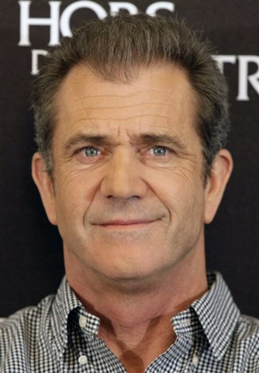 FILE - In this Feb. 4, 2010 file photo, actor Mel Gibson looks on during a photocall to promote the movie "Edge of Darkness", in Paris. Gibson is expected to be charged Friday March 11, 2011 with misdemeanor battery and appear in a Los Angeles courtroom to plead guilty and be sentenced. (AP Photo/Francois Mori, file)