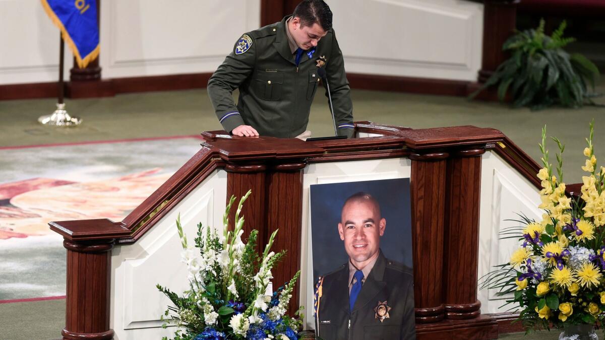California Highway Patrol Officer Jonathan Velasquez, Andrew Camilleri's partner, breaks down as he says a few words at a memorial service for Camilleri in Stockton.