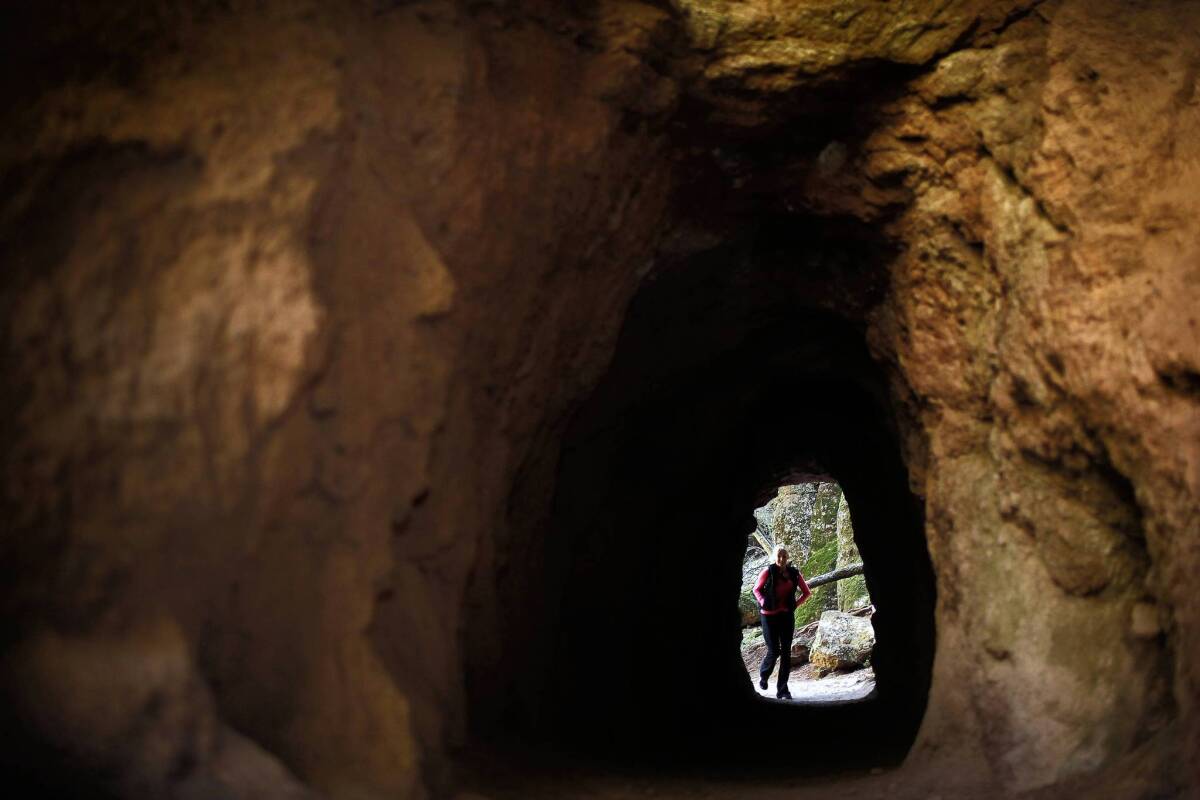 Bernadette Carter, 49, of Hollister, Calif., walks through a man-made tunnel at the new Pinnacles National Park. Officials of the nearby town of Soledad, which sits outside the park's west entrance, hope park tourists will also come their way.