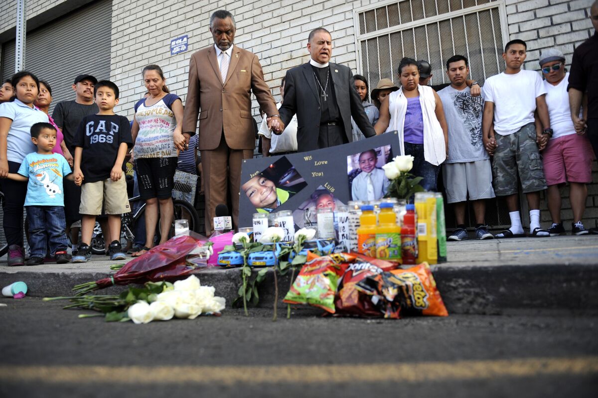 People gathered at the crime scene Wednesday night and placed flowers, candles and food including Cheez-Its and Doritos — the children’s favorite snacks — on the sidewalk.