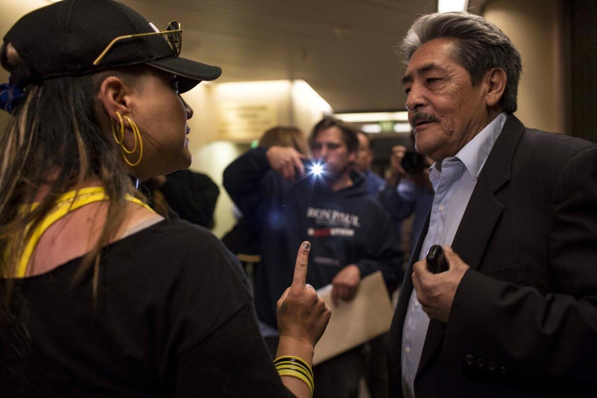 Jennifer Otte and Andres Valdez argue before a boisterous Albuquerque City Council meeting, at which council members agreed to discuss whether to change the way the city selects its police chief.