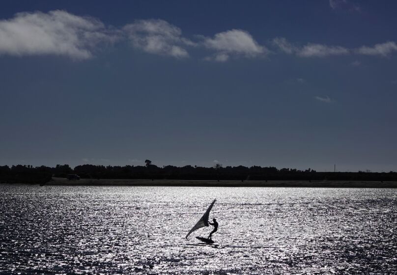 A person rides a wing foil board on a breezy afternoon in Mission Bay on Tuesday, September 20, 2022.