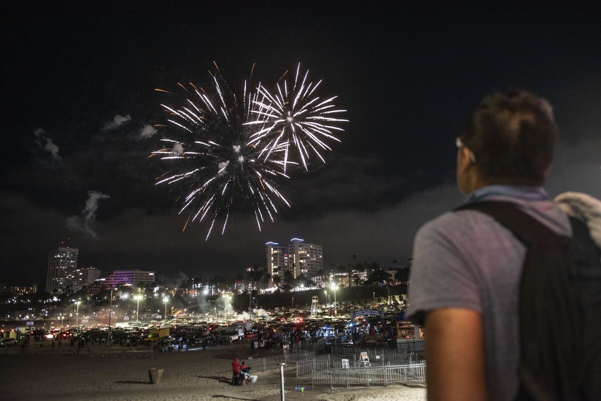 Fireworks go off above Santa Monica.