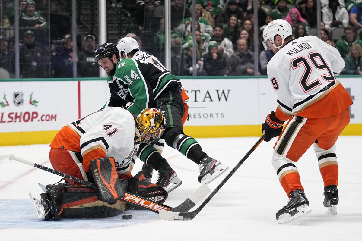 Ducks goalie Anthony Stolarz blocks a shot by Dallas Stars left wing Jamie Benn as defenseman Dmitry Kulikov helps Stolarz.